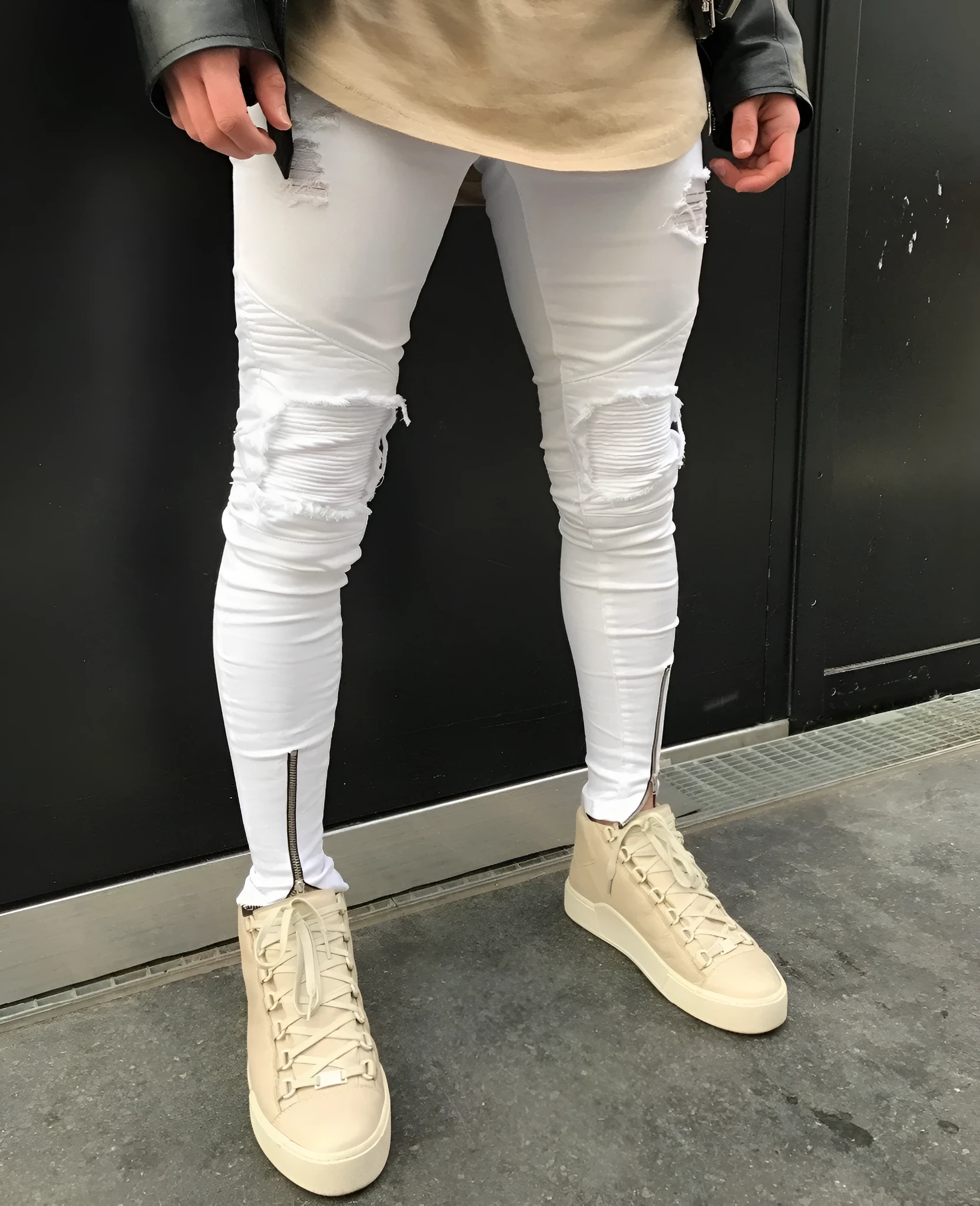 Ripped zipper jeans in black for women with stretch denim and multiple metal zippers on the legs