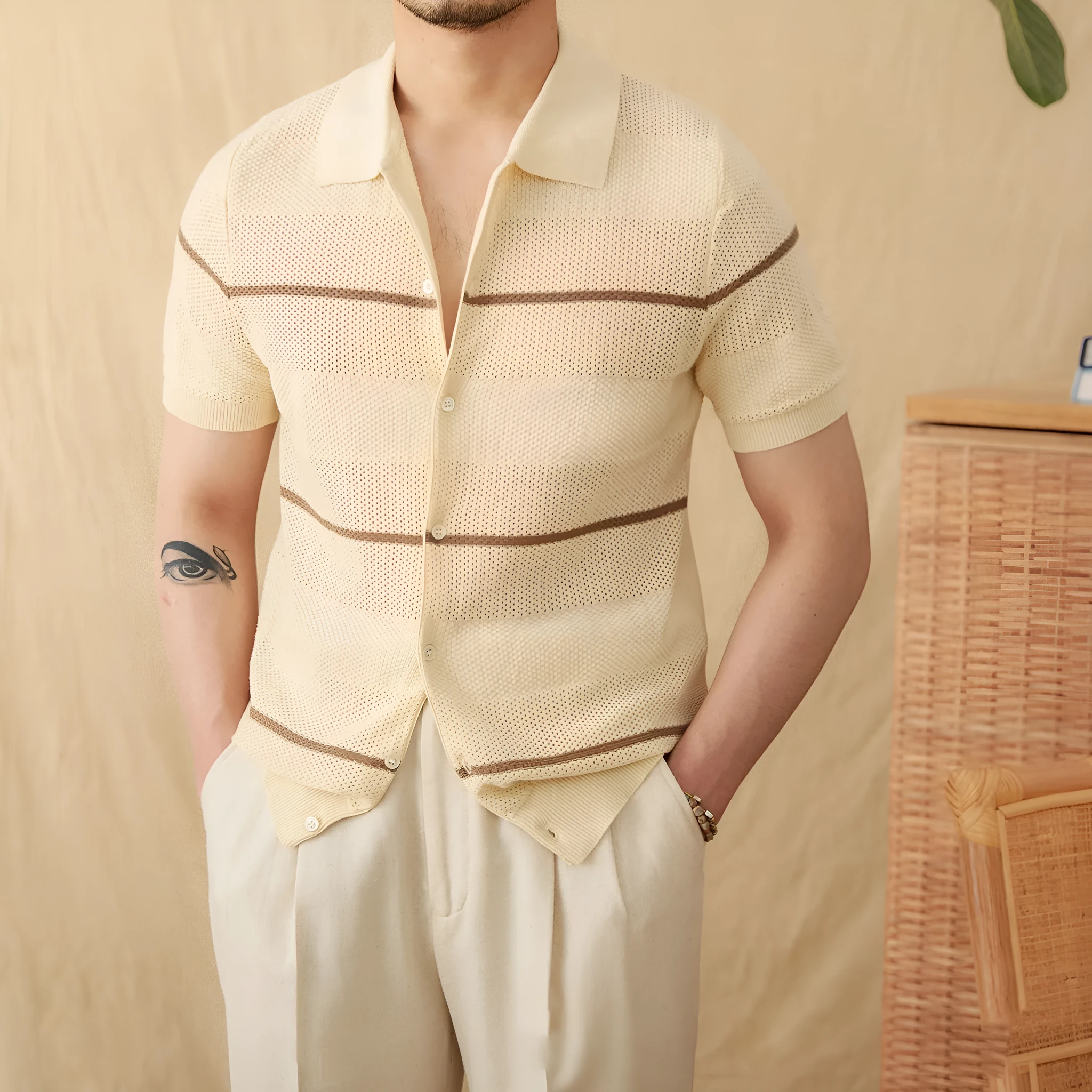 Men's camel coloured short sleeve knitted cardigan with a lapel collar on a hanger.