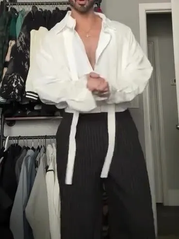 White oversized tie-front shirt with relaxed fit, open collar, and regular-length cut on a plain background