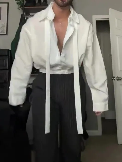 White oversized tie-front shirt with relaxed fit, open collar, and regular-length cut on a plain background