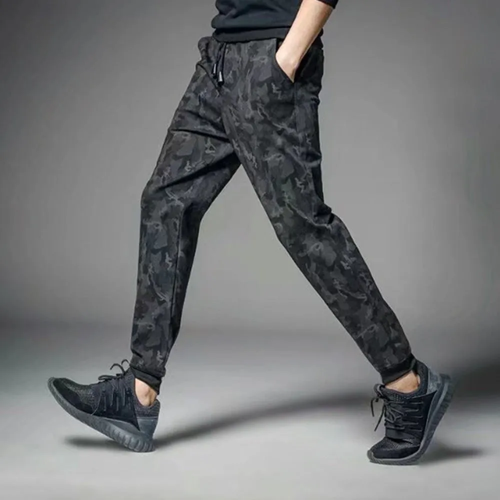 Men's black jogging pants made from acetate and modal fabric, side view on model