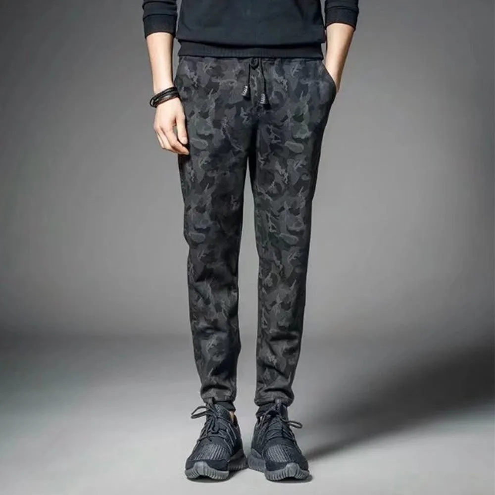 Men's black jogging pants made from acetate and modal fabric, side view on model