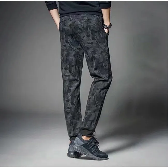 Men's black jogging pants made from acetate and modal fabric, side view on model