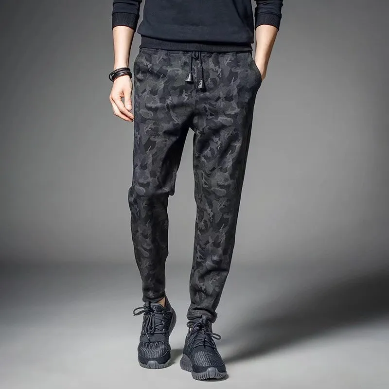 Men's black jogging pants made from acetate and modal fabric, side view on model