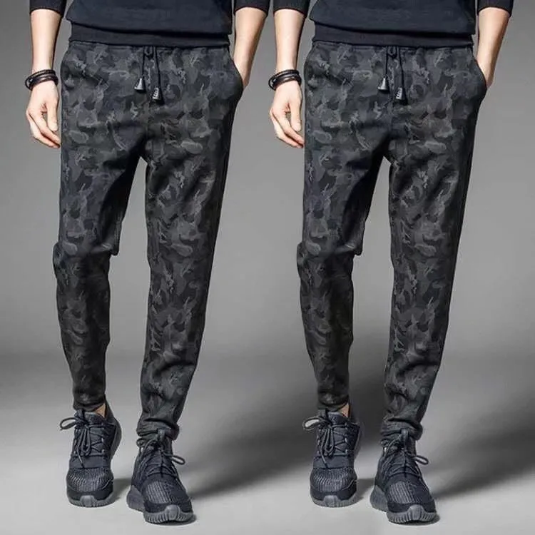 Men's black jogging pants made from acetate and modal fabric, side view on model