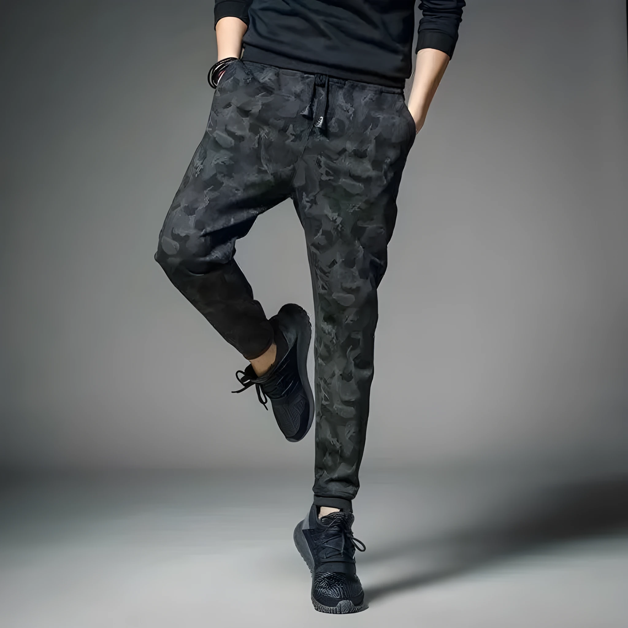 Men's black jogging pants made from acetate and modal fabric, side view on model