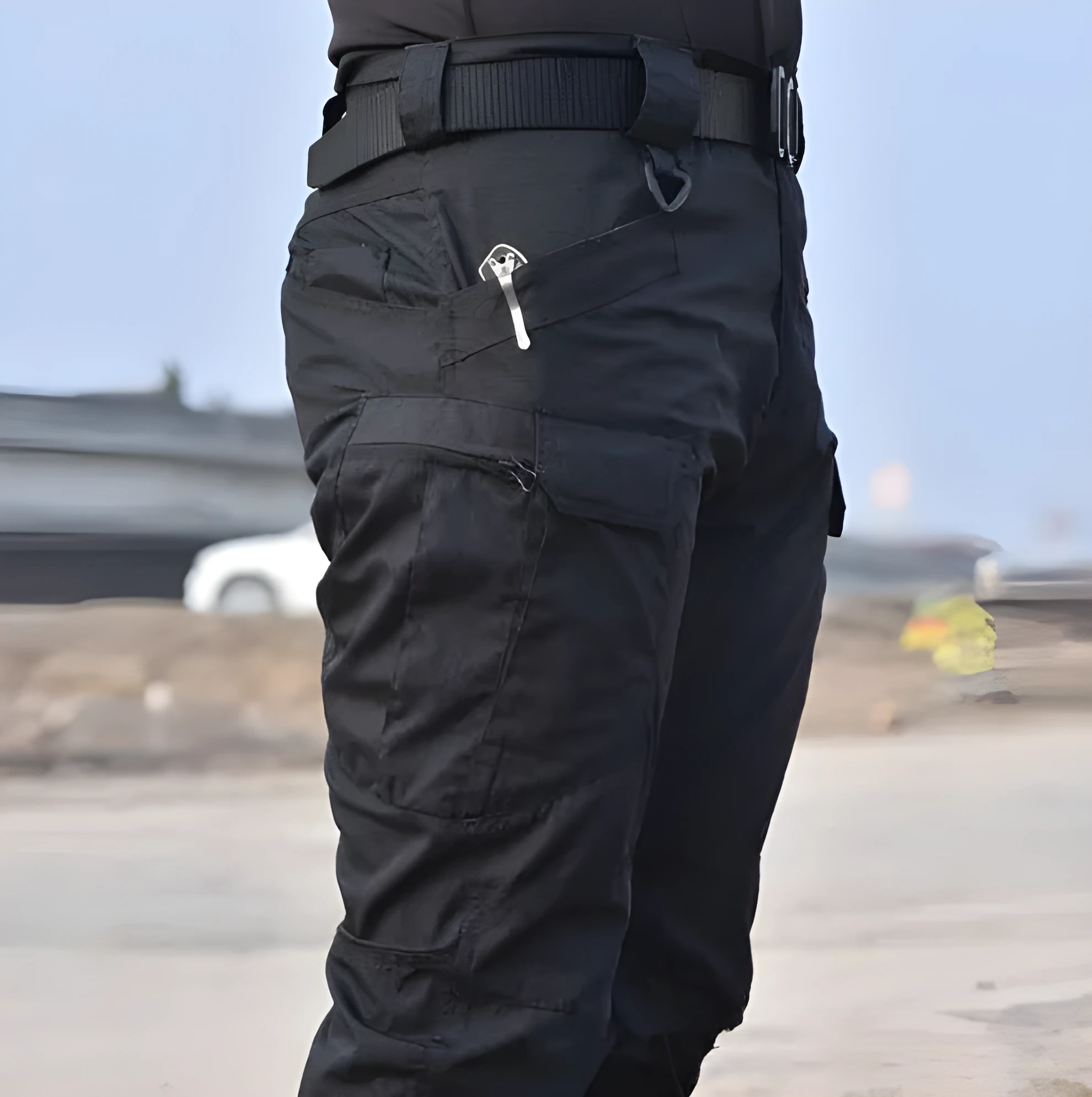 Outdoor multi-legged tactical pants in khaki cotton blend with multiple pockets on legs, shown against natural background