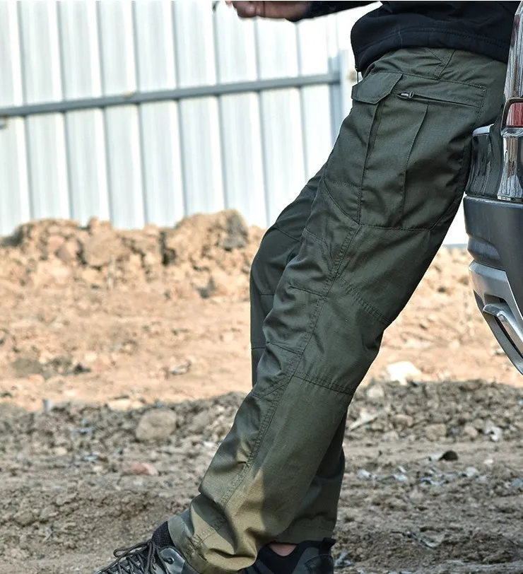 Outdoor multi-legged tactical pants in khaki cotton blend with multiple pockets on legs, shown against natural background