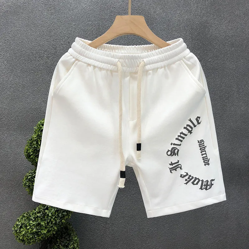 Printed cropped polyester sports pants in black for teenage men, side view showing cropped leg length