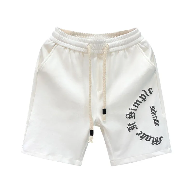 Printed cropped polyester sports pants in black for teenage men, side view showing cropped leg length