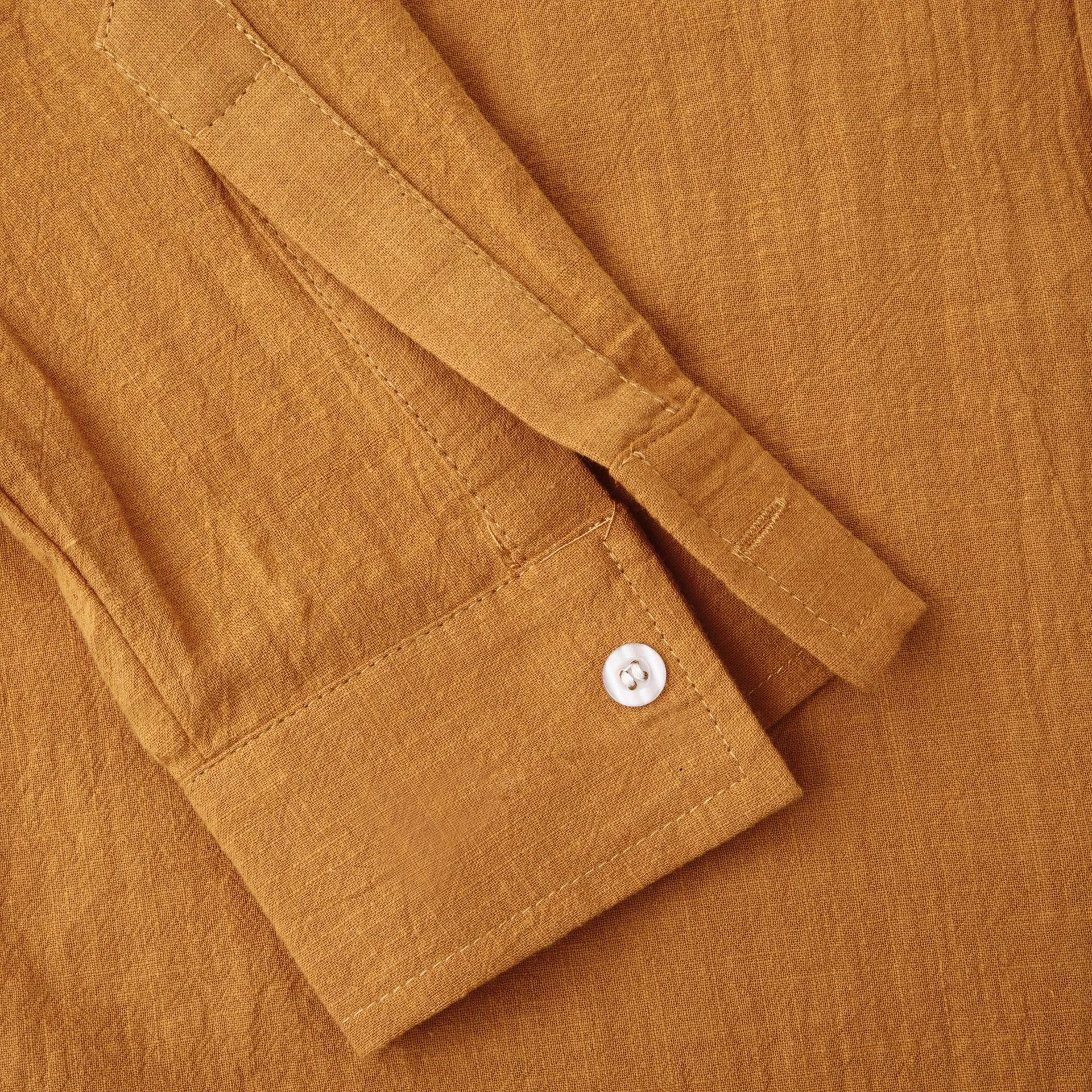 Men's brown slim cotton blend shirt with long sleeves on mannequin showing fitted design