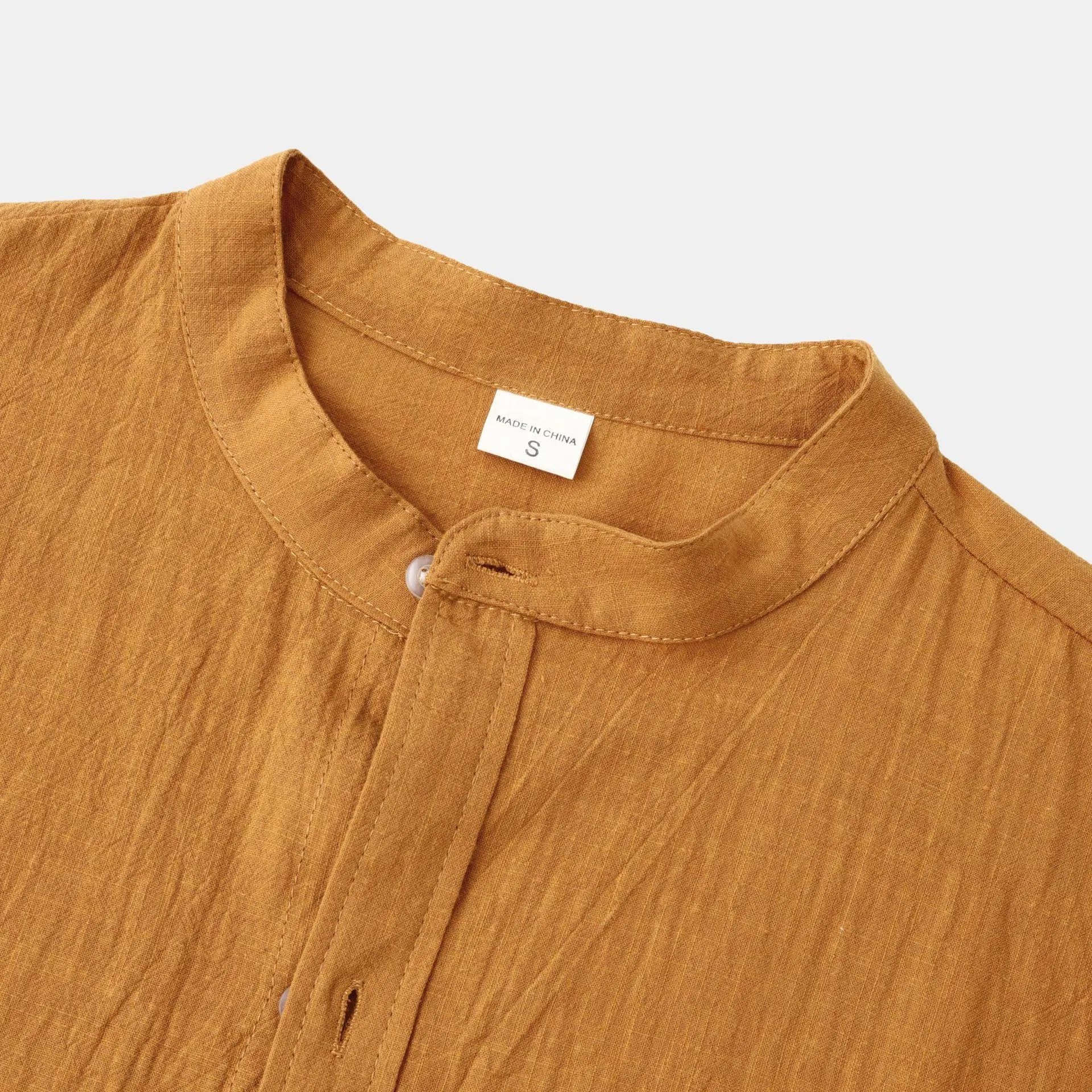 Men's brown slim cotton blend shirt with long sleeves on mannequin showing fitted design