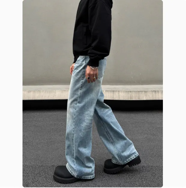 Men's blue straight-leg jeans with whisker wash detailing and a flared leg.