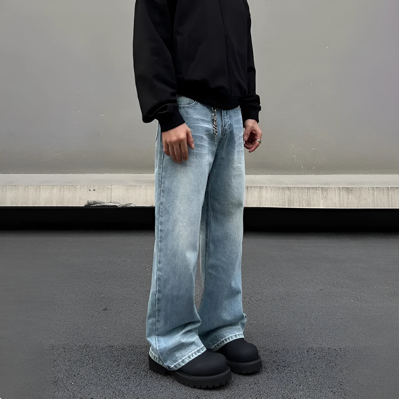 Men's blue straight-leg jeans with whisker wash detailing and a flared leg.