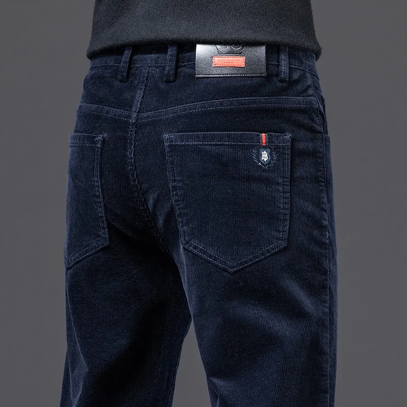 Men's thick corduroy straight trousers with belt in dark grey, shown folded on a neutral background.
