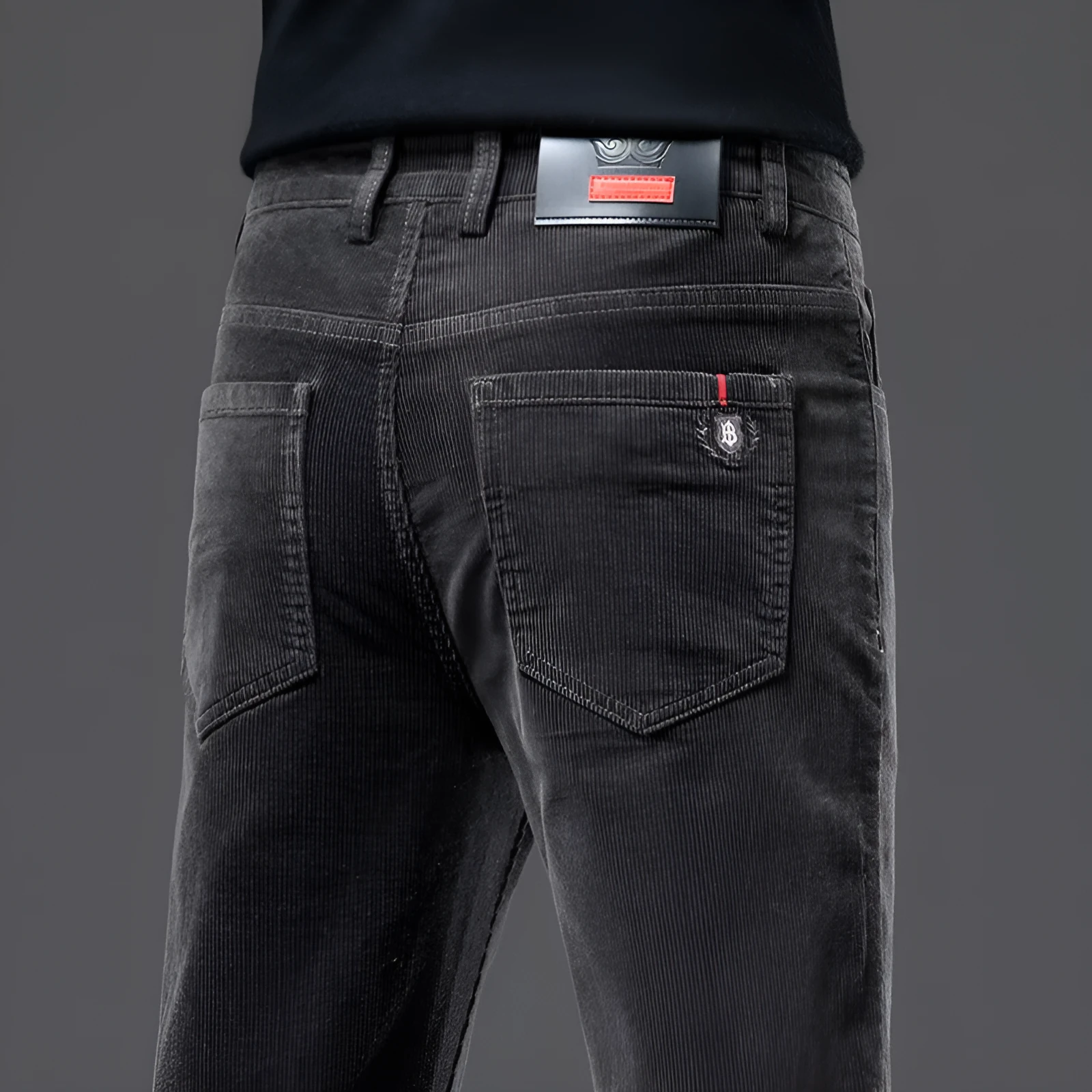 Men's thick corduroy straight trousers with belt in dark grey, shown folded on a neutral background.