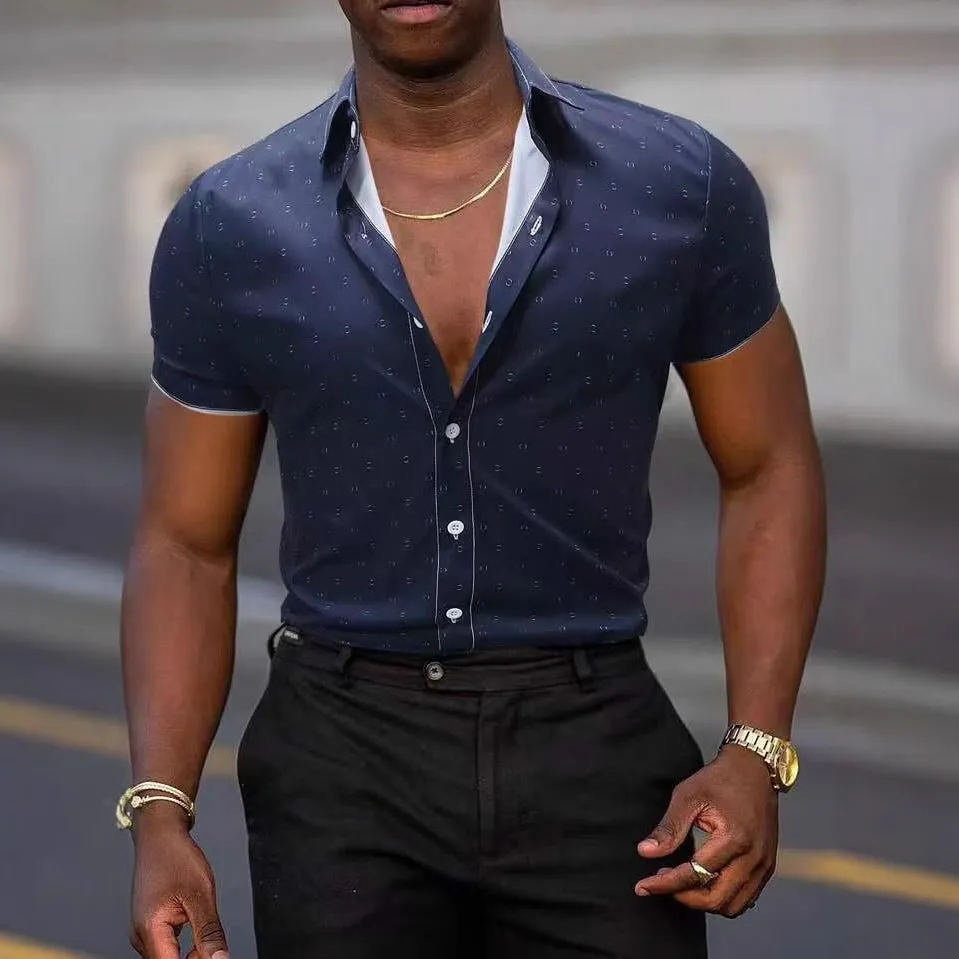 Man wearing a light blue short-sleeved casual shirt with a floral print pattern.