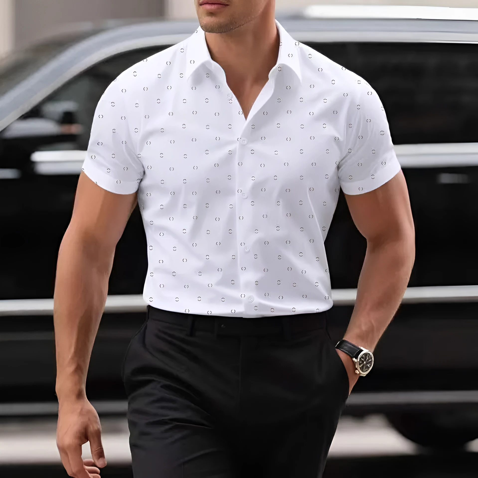 Man wearing a light blue short-sleeved casual shirt with a floral print pattern.
