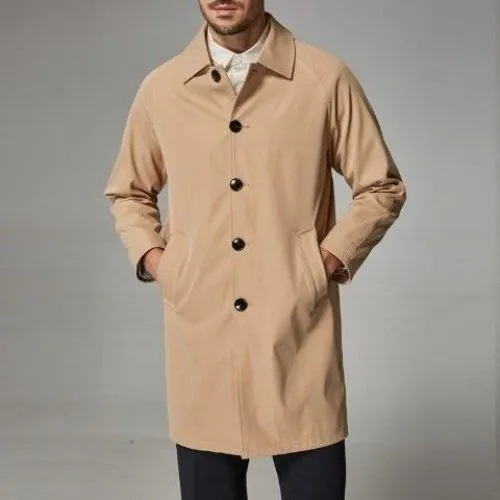 Man wearing a khaki-coloured, loose-fit mid-length trench coat made of rabbit fur.