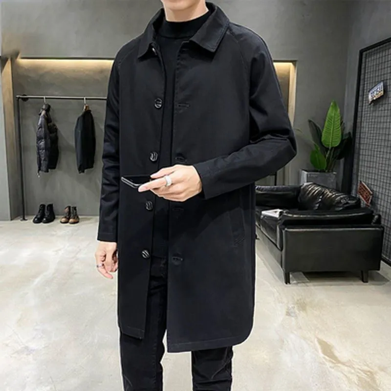 Man wearing a khaki-coloured, loose-fit mid-length trench coat made of rabbit fur.