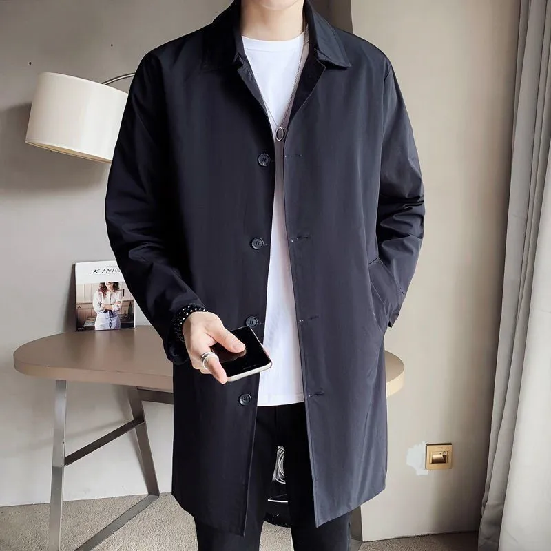 Man wearing a khaki-coloured, loose-fit mid-length trench coat made of rabbit fur.