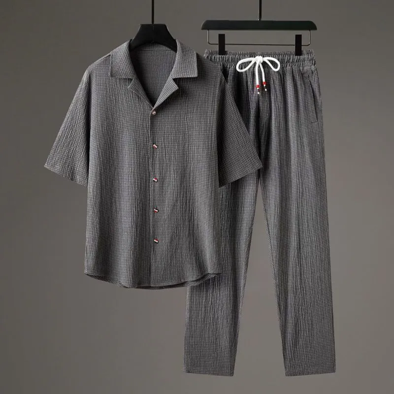 Men's grey Chinese-style casual two-piece sportswear set with short sleeve top and trousers on a hanger.