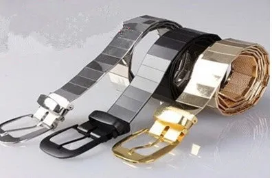 Three shiny belts in gold, silver, and black metallic finish arranged together