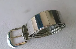 Three shiny belts in gold, silver, and black metallic finish arranged together