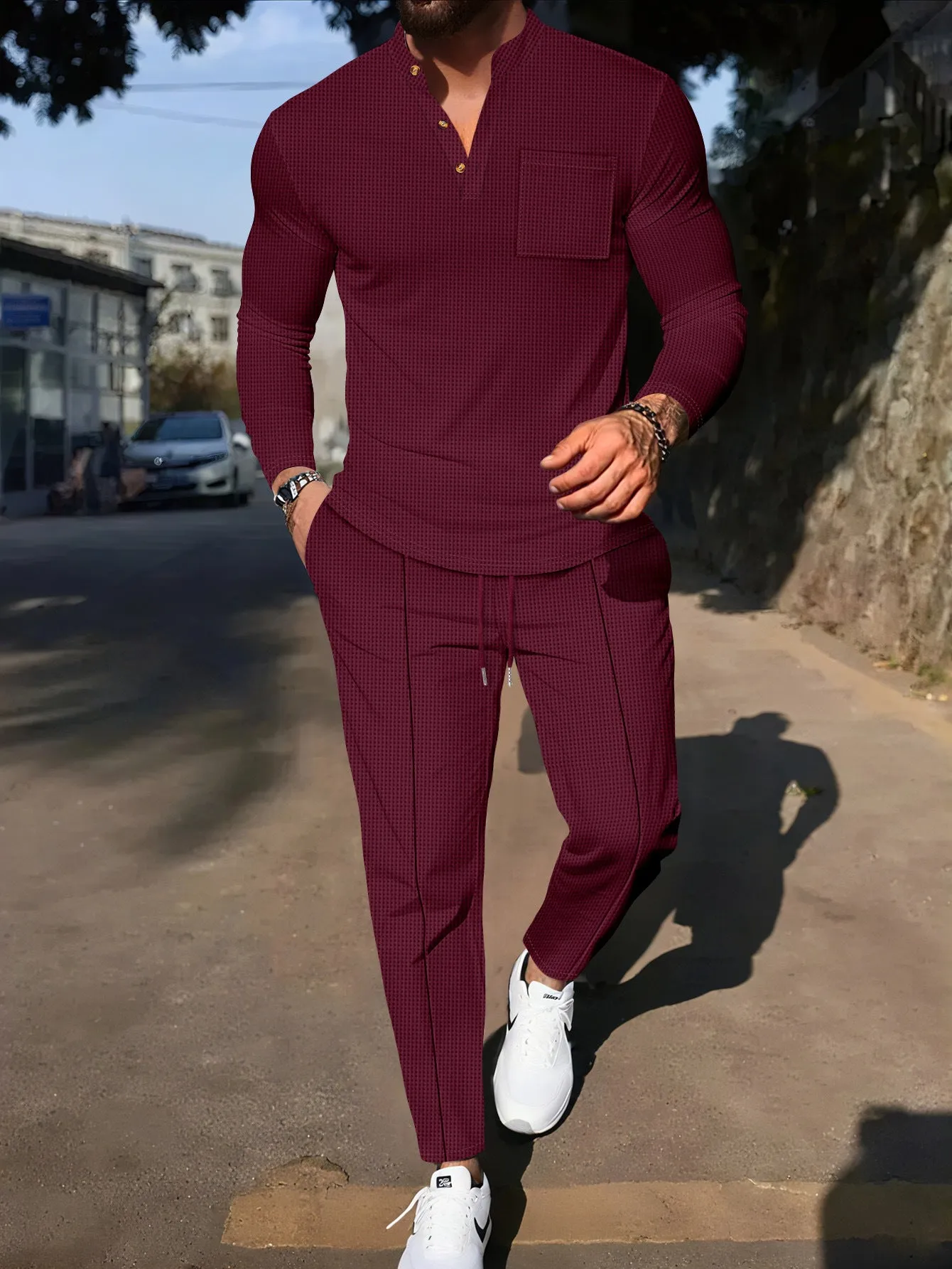 Men's waffle henley long sleeve t-shirt and matching long pants casual set in gray on a model