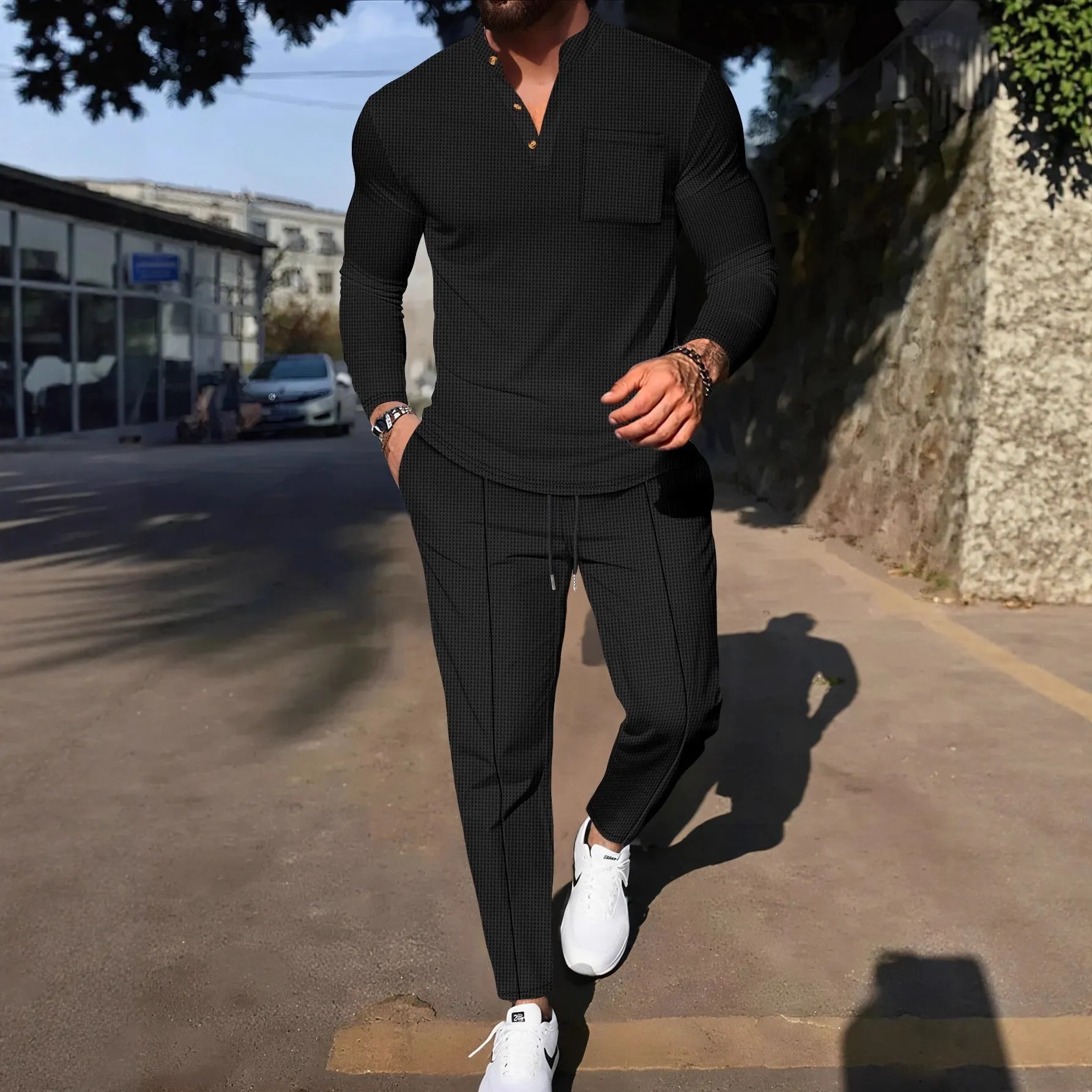 Men's waffle henley long sleeve t-shirt and matching long pants casual set in gray on a model