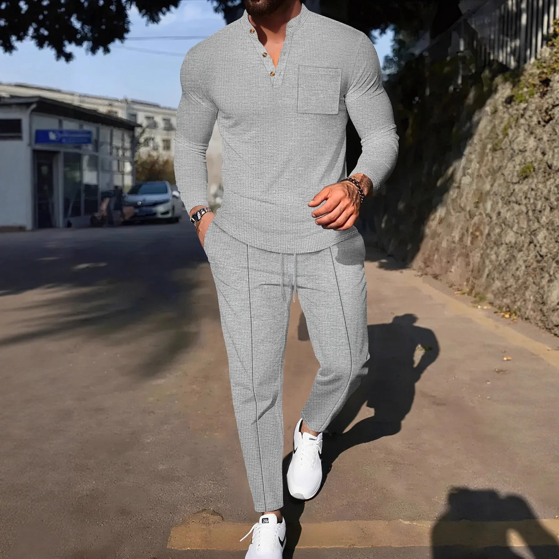 Men's waffle henley long sleeve t-shirt and matching long pants casual set in gray on a model