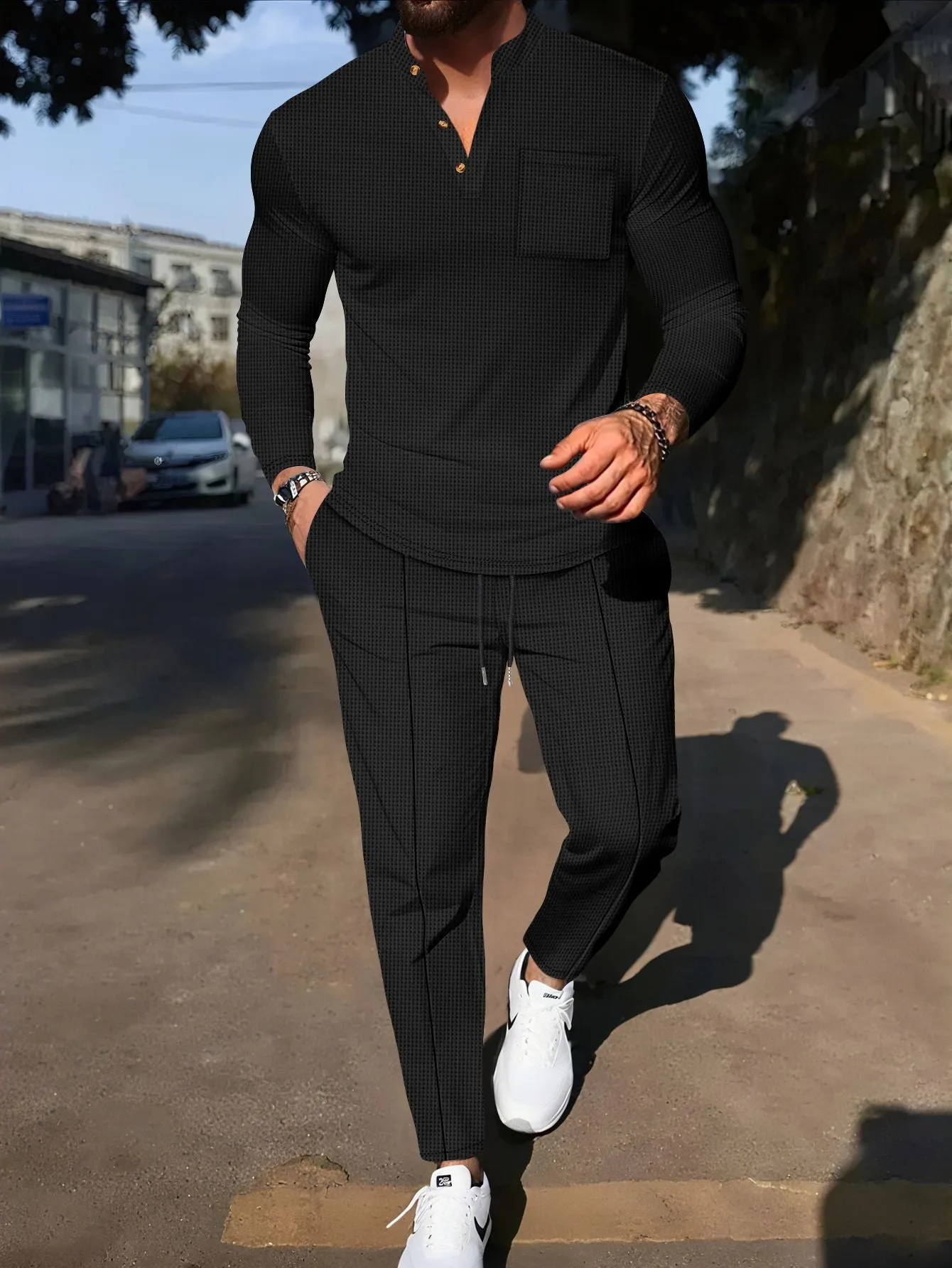 Men's waffle henley long sleeve t-shirt and matching long pants casual set in gray on a model