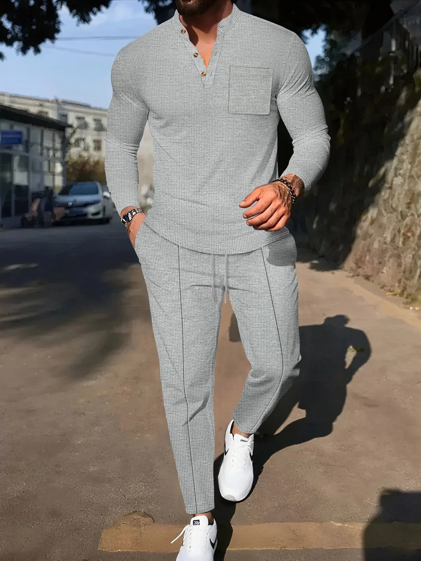 Men's waffle henley long sleeve t-shirt and matching long pants casual set in gray on a model
