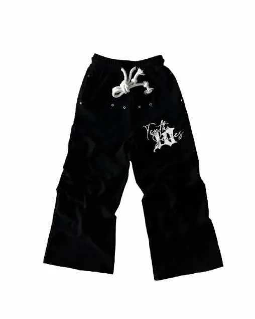 Black fleece embroidered printed loose fit pullover sweatpants on a model