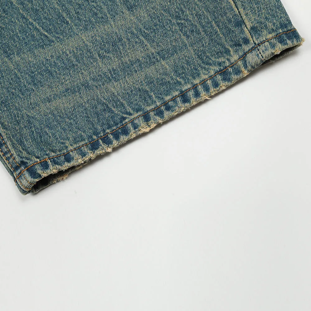 Retro distressed jeans for men in vintage blue cotton denim with worn-in finish, front view