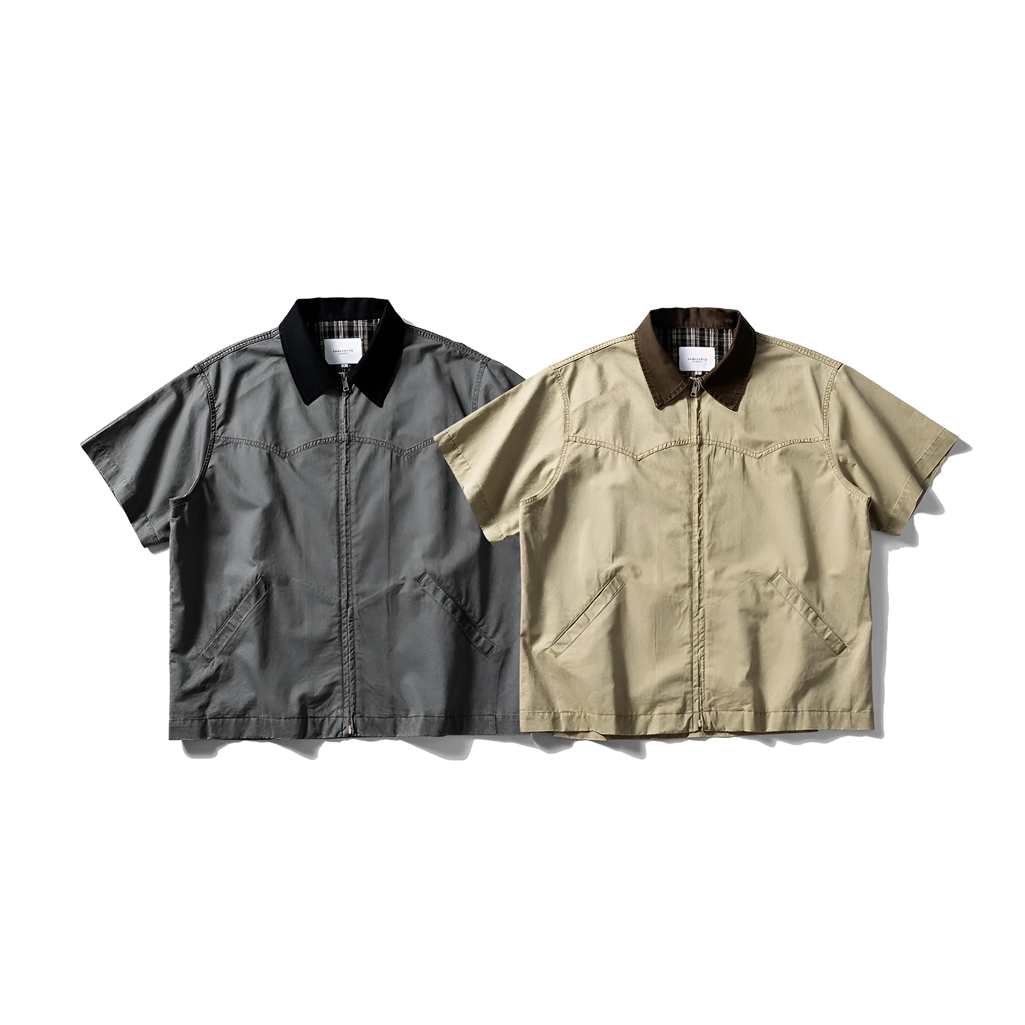 A khaki-coloured, short-sleeved overalls shirt with a loose cardigan style on a hanger.
