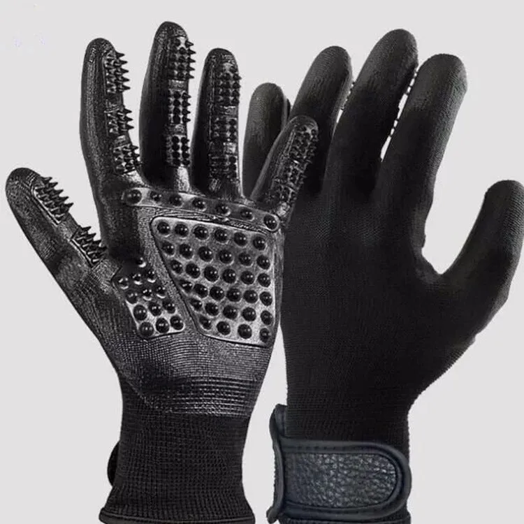 Pet hair grooming glove in black rubber with adjustable wrist strap on a light background