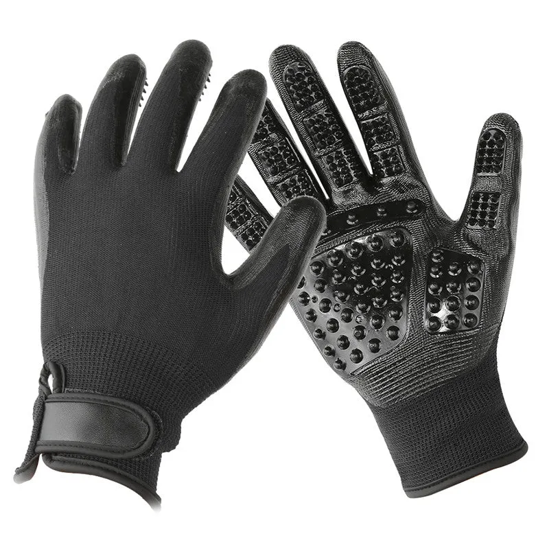 Pet hair grooming glove in black rubber with adjustable wrist strap on a light background