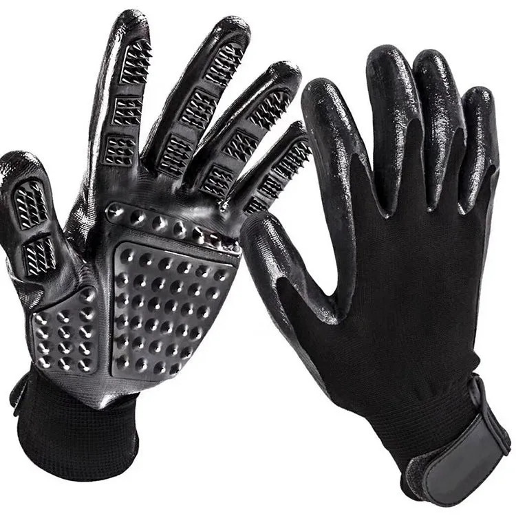 Pet hair grooming glove in black rubber with adjustable wrist strap on a light background