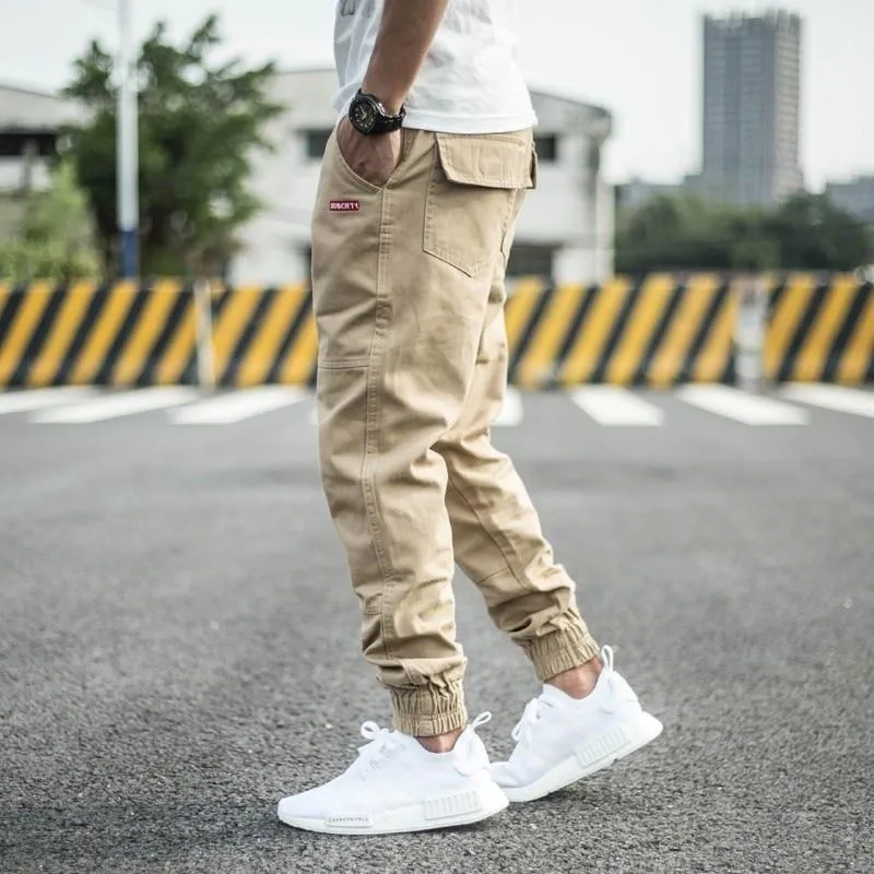 Men's casual tight-fitting pencil trousers in Khaki, front view, zipper placket visible