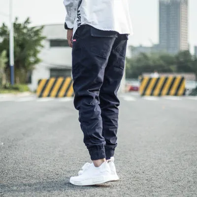 Men's casual tight-fitting pencil trousers in Khaki, front view, zipper placket visible
