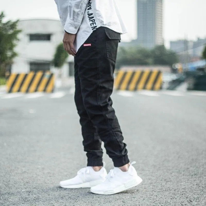Men's casual tight-fitting pencil trousers in Khaki, front view, zipper placket visible