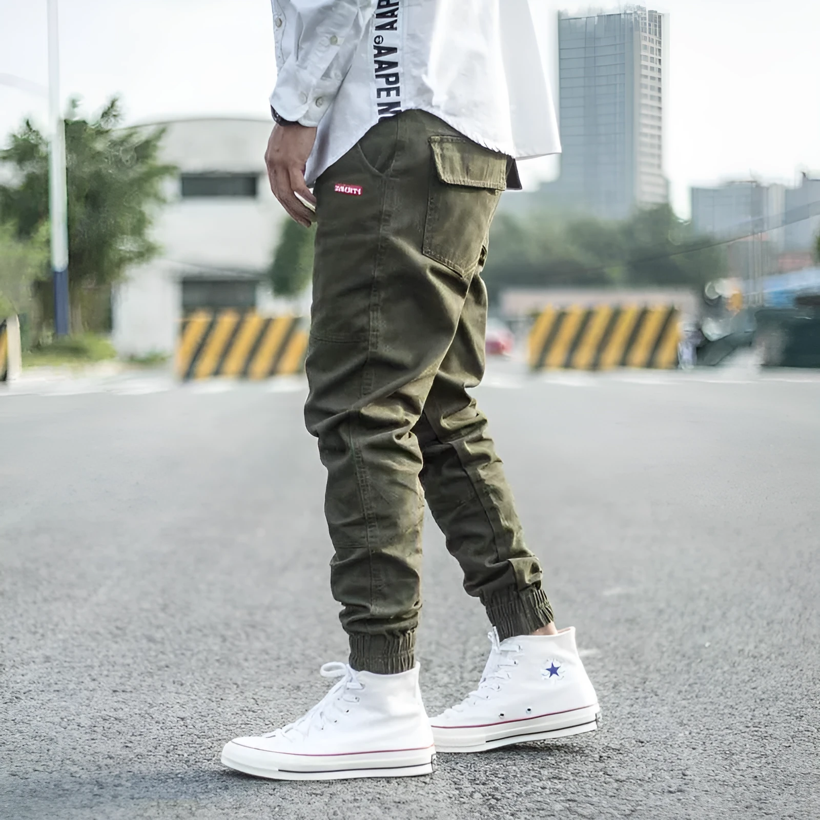 Men's casual tight-fitting pencil trousers in Khaki, front view, zipper placket visible