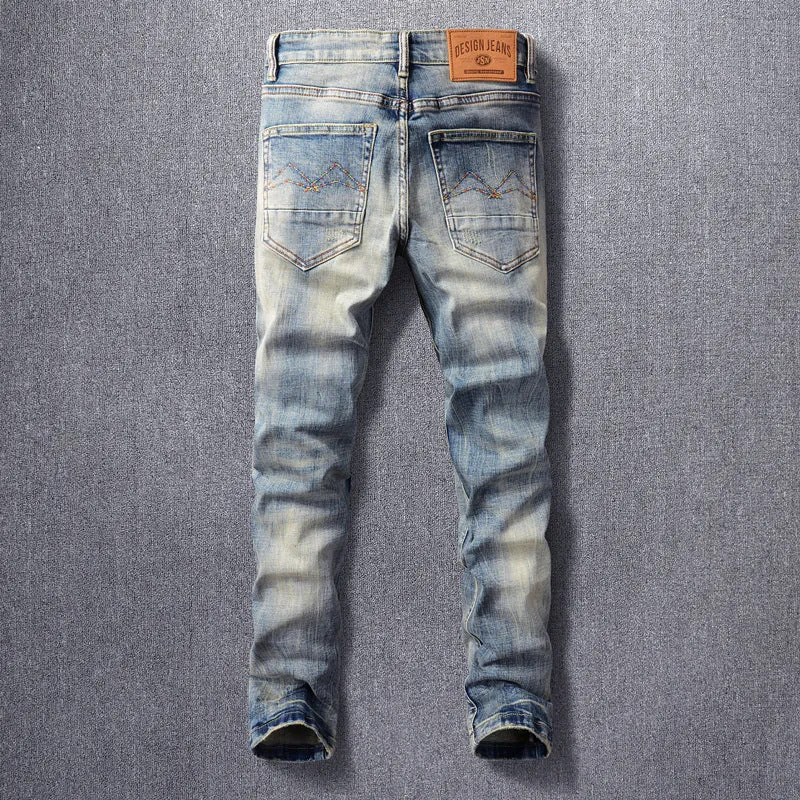 Men's distressed blue straight leg jeans with frayed hem and multiple pockets