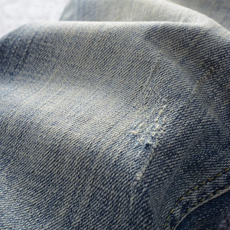 Men's distressed blue straight leg jeans with frayed hem and multiple pockets