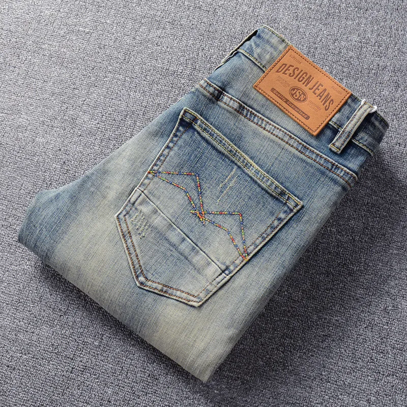 Men's distressed blue straight leg jeans with frayed hem and multiple pockets