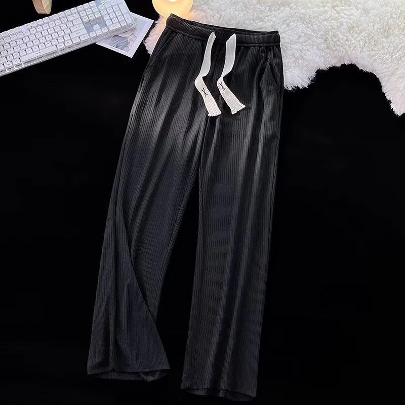 Men's loose straight-leg casual cotton trousers in black, shown flat.