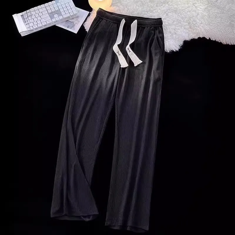 Men's loose straight-leg casual cotton trousers in black, shown flat.