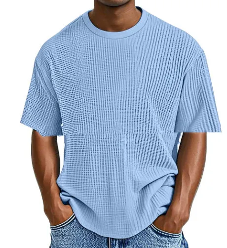 Man wearing a light blue cotton blend waffle knit short sleeve casual T-shirt.