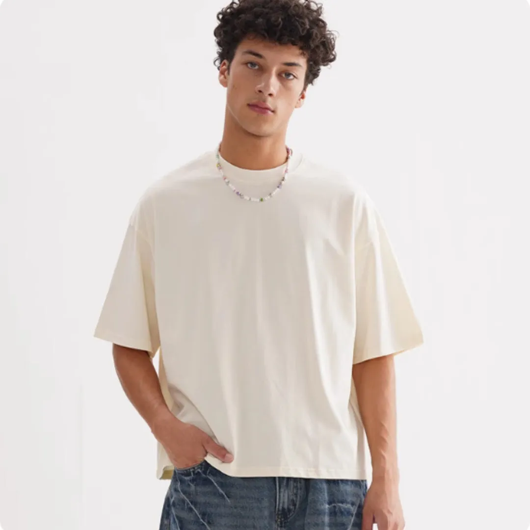 Pure cotton American-style loose fit T-shirt shown in apricot colour on a hanger.